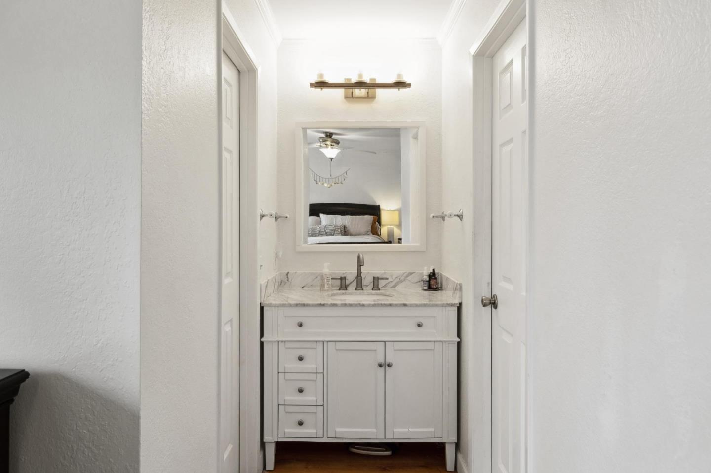 1287 Rosita Road Pacifica, CA 94044 - Photo 38 of 76 a bathroom with a sink vanity and a mirror