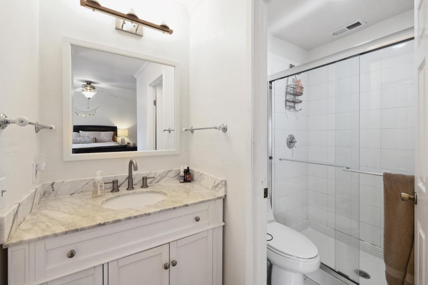 1287 Rosita Road Pacifica, CA 94044 - Photo 39 of 76 a bathroom with a granite countertop sink toilet and shower