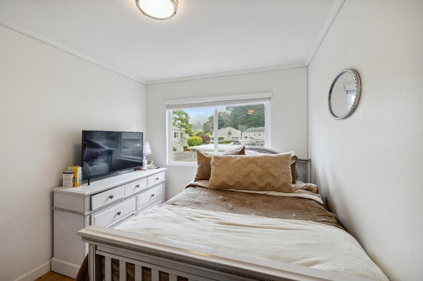 1287 Rosita Road Pacifica, CA 94044 - Photo 44 of 76 a living room with furniture and a flat screen tv