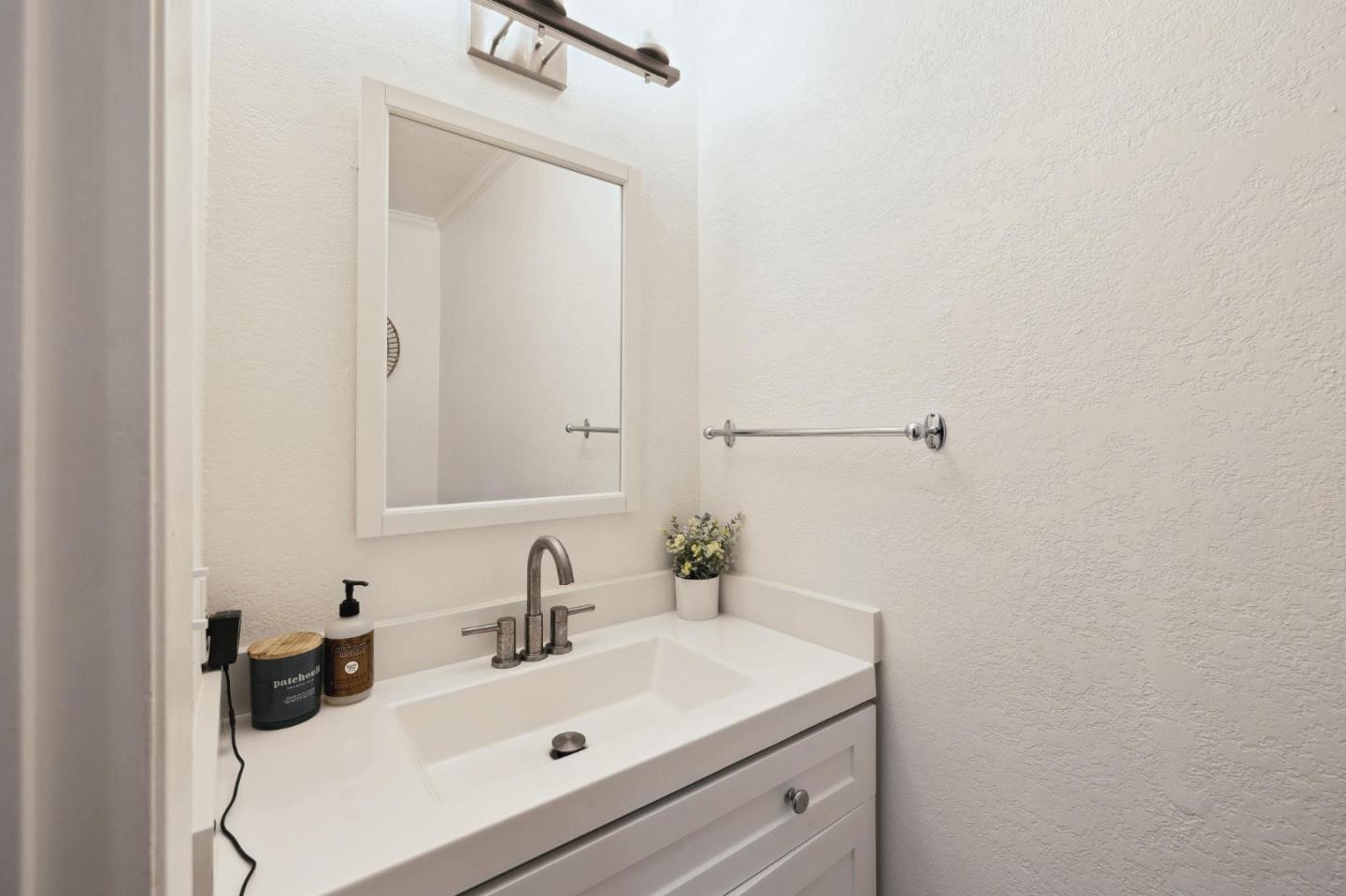 1287 Rosita Road Pacifica, CA 94044 - Photo 45 of 76 a bathroom with a sink and a mirror