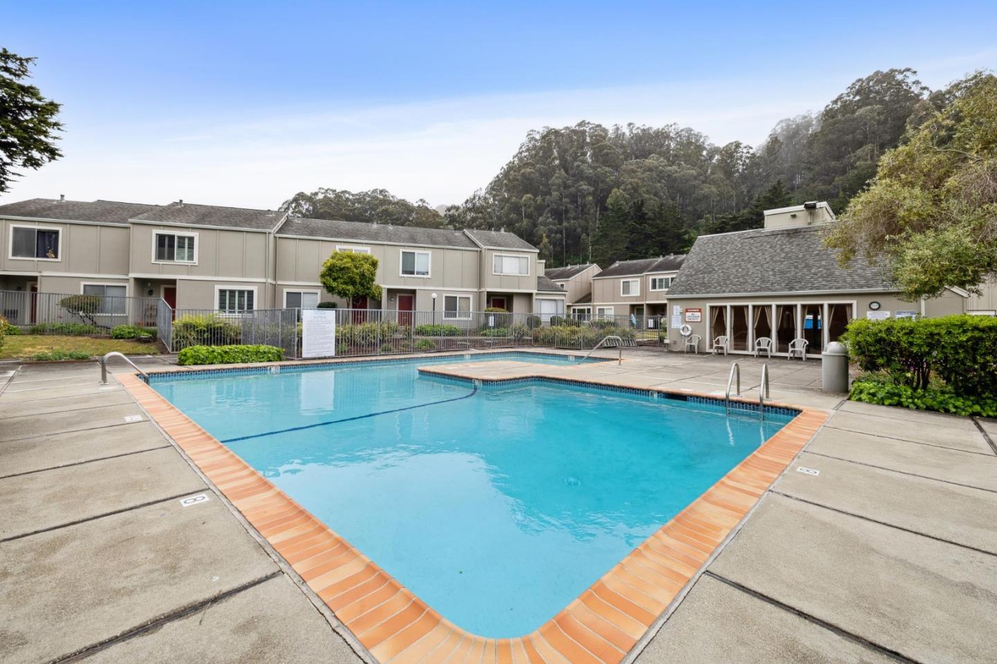 1287 Rosita Road Pacifica, CA 94044 - Photo 52 of 76 a view of swimming pool with outdoor seating and house in the background