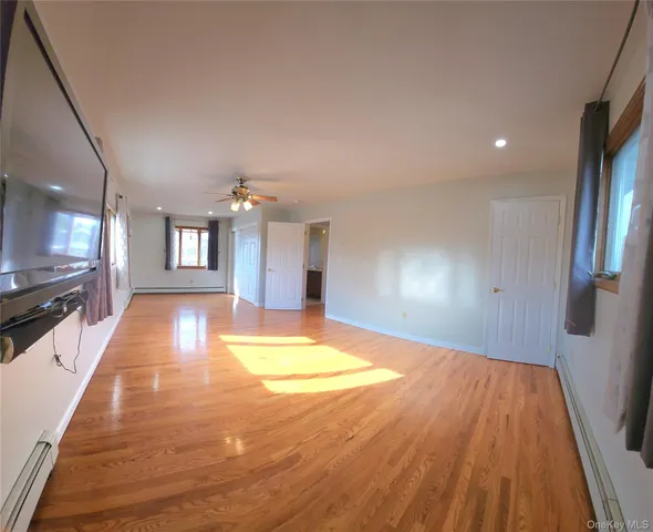 a view of livingroom with hardwood floor and a ceiling fan