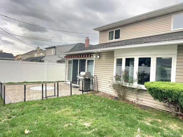 a front view of a house with a yard and seating space