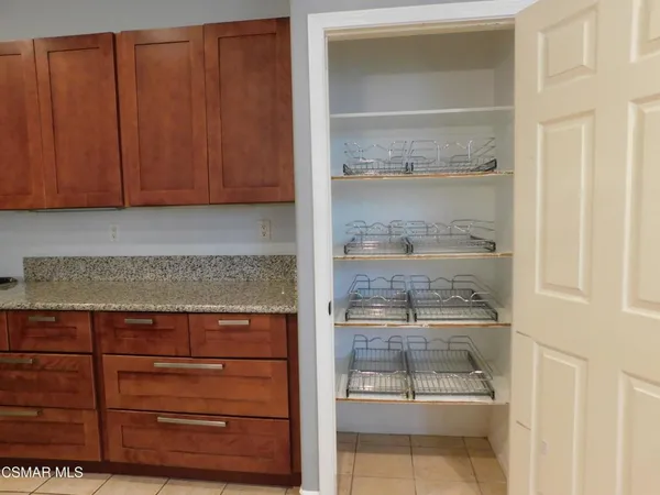 a view of counter top space with empty shelves