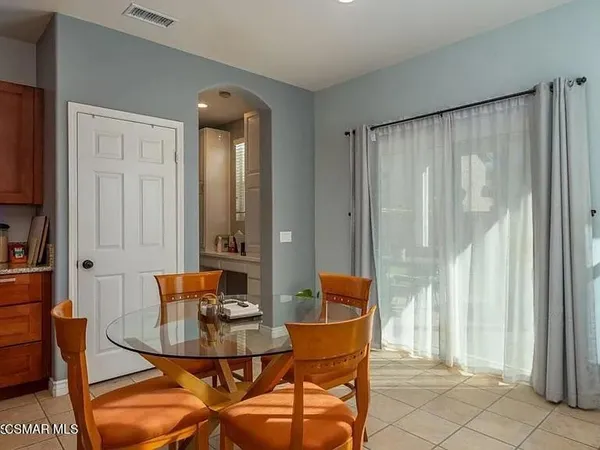 a view of a dining room with furniture and a window