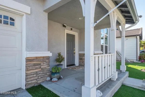 a view of a porch with wooden floor and a yard
