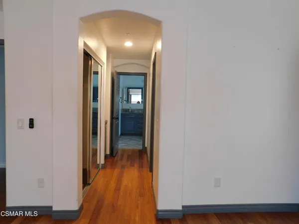a view of a hallway with wooden floor
