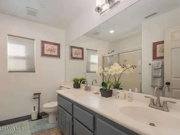 a bathroom with a double vanity sink and a mirror