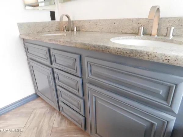 a bathroom with a granite countertop sink and vanity