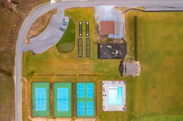a view of swimming pool with a table and chairs in the patio