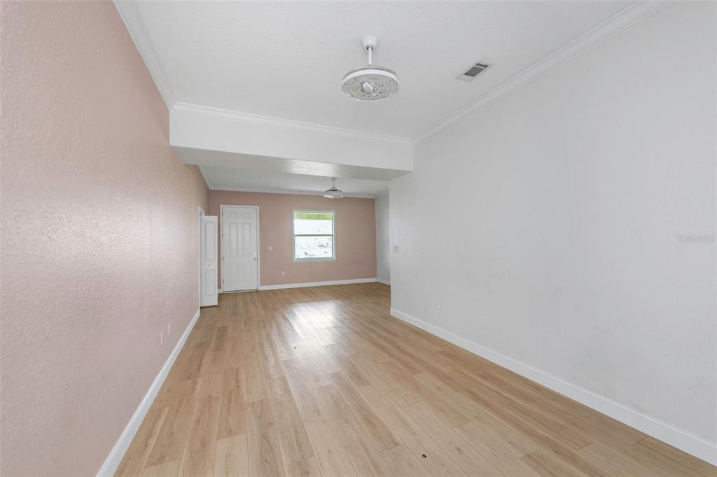 20138 Bowman Road Spring Hill, FL 34610 - Photo 23 of 40 a view of empty room with window and wooden floor