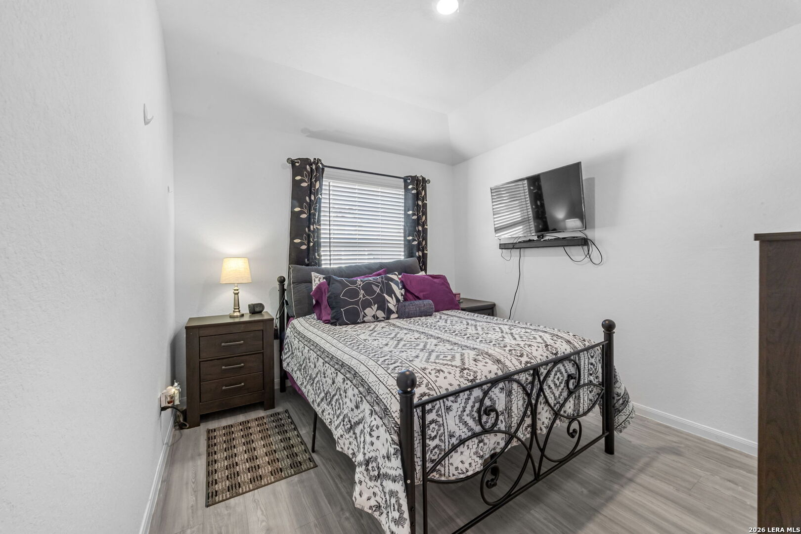 5781 Companion Loop Bulverde, TX 78163 - Photo 13 of 21 a bedroom with a bed and flat tv screen on a dresser