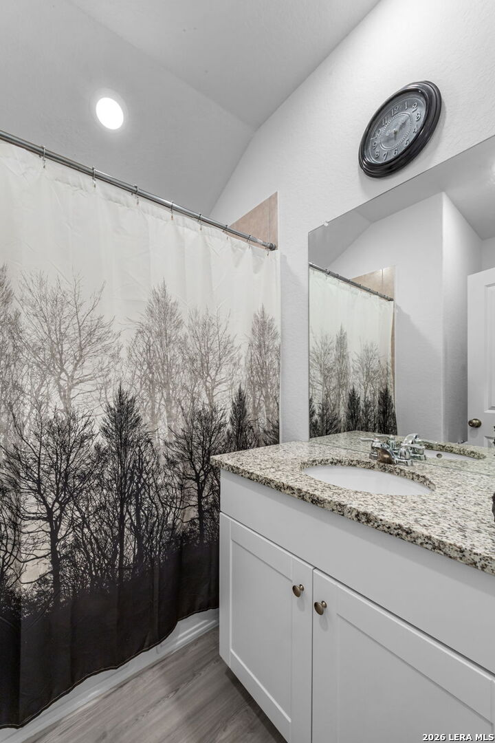 5781 Companion Loop Bulverde, TX 78163 - Photo 14 of 21 a bathroom with a granite countertop sink and a mirror