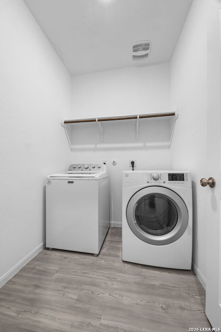5781 Companion Loop Bulverde, TX 78163 - Photo 16 of 21 a utility room with dryer and washer