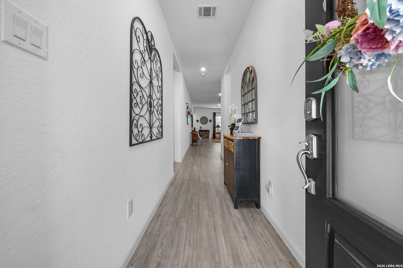 5781 Companion Loop Bulverde, TX 78163 - Photo 2 of 21 a view of a hallway with wooden floor and stairs