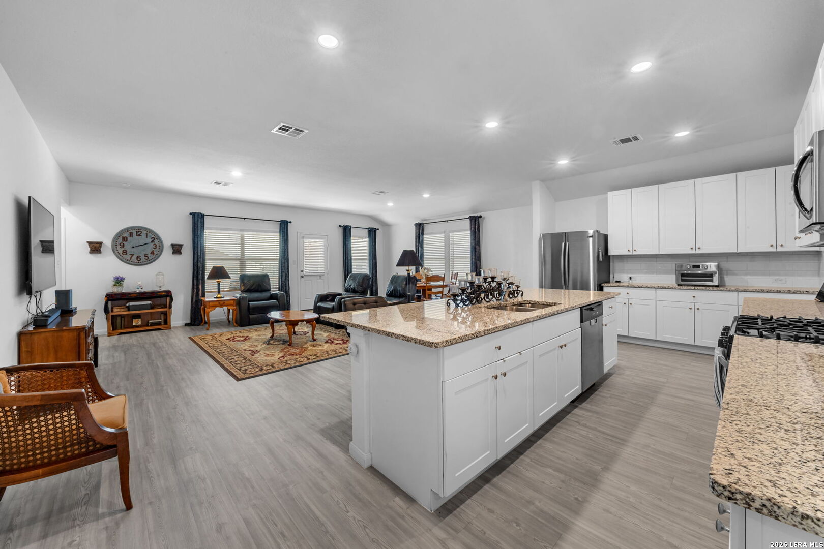 5781 Companion Loop Bulverde, TX 78163 - Photo 3 of 21 a large white kitchen with lots of counter space wooden floor and appliances