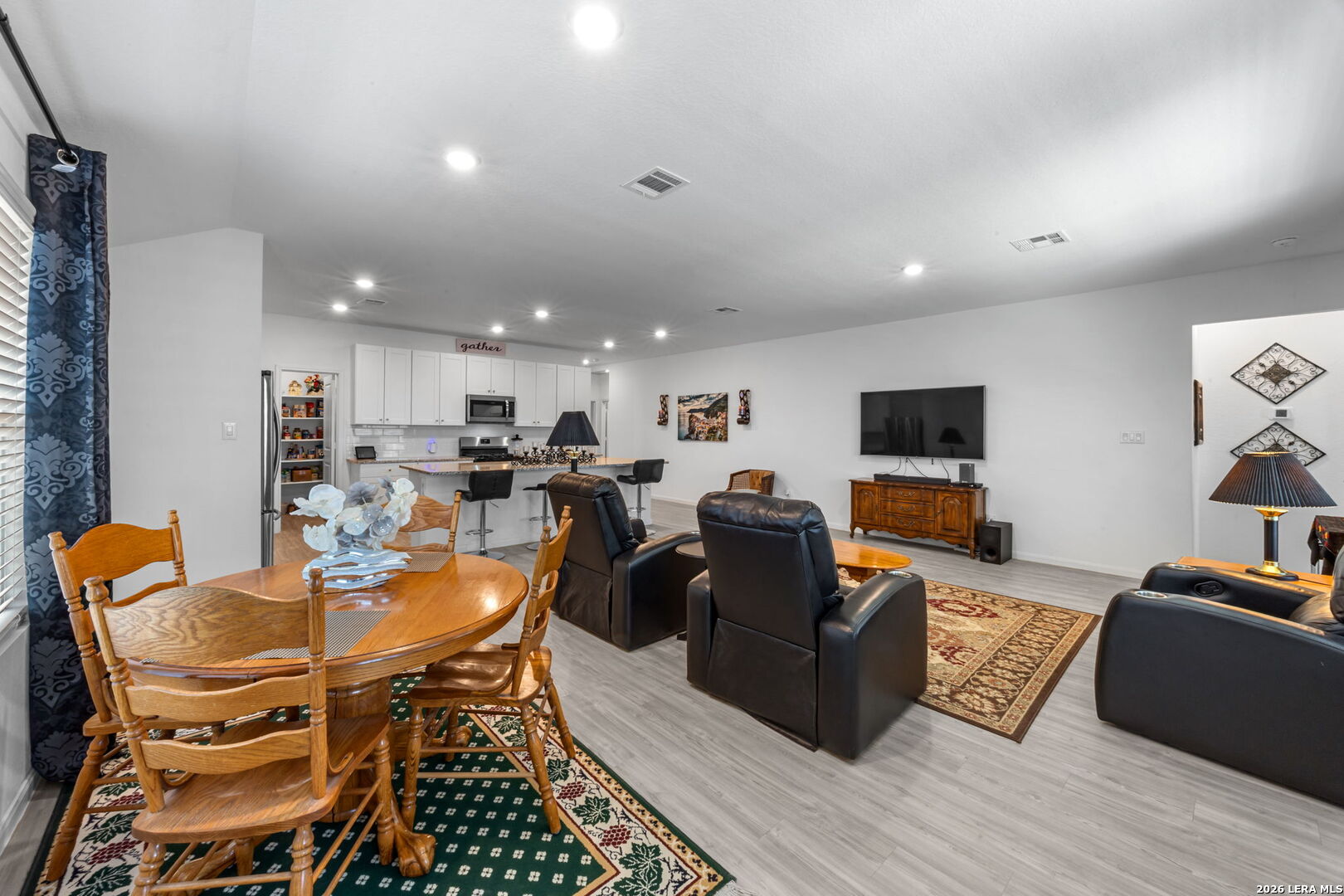 5781 Companion Loop Bulverde, TX 78163 - Photo 5 of 21 a living room with furniture a flat screen tv and kitchen view