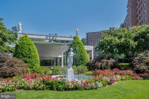 a view of a house with a yard and potted plants