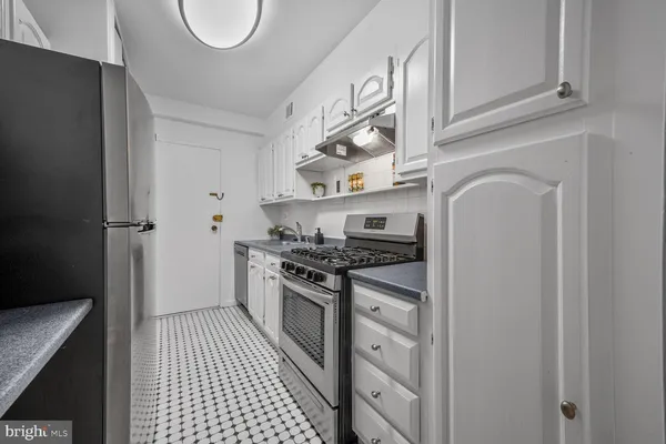 a kitchen with stainless steel appliances granite countertop a stove and a refrigerator