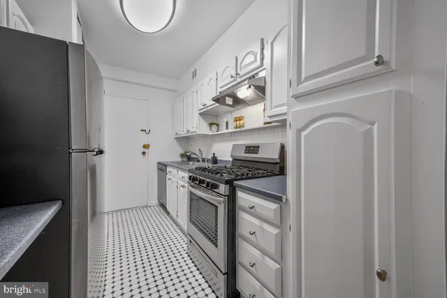 a kitchen with stainless steel appliances granite countertop a stove and a refrigerator