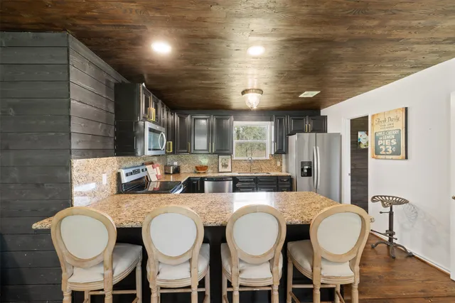 a bathroom with a granite countertop a dining table and chairs