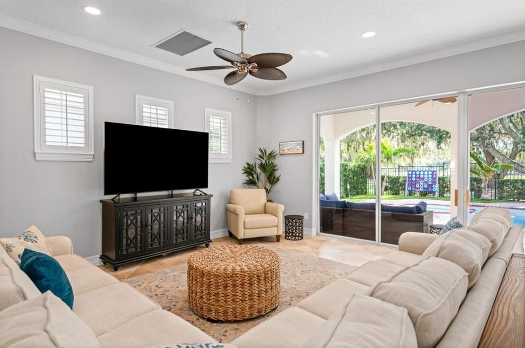 1227 Radiant Street Reunion, FL 34747 - Photo 12 of 70 a living room with furniture a large window and a flat screen tv