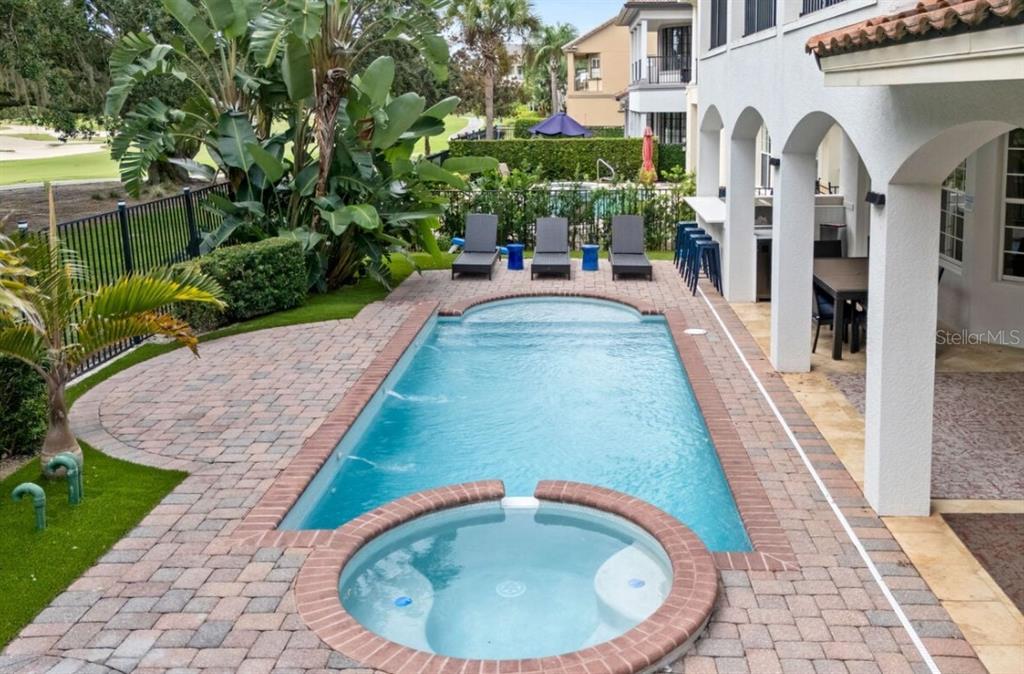 1227 Radiant Street Reunion, FL 34747 - Photo 13 of 70 a view of a swimming pool with a porch