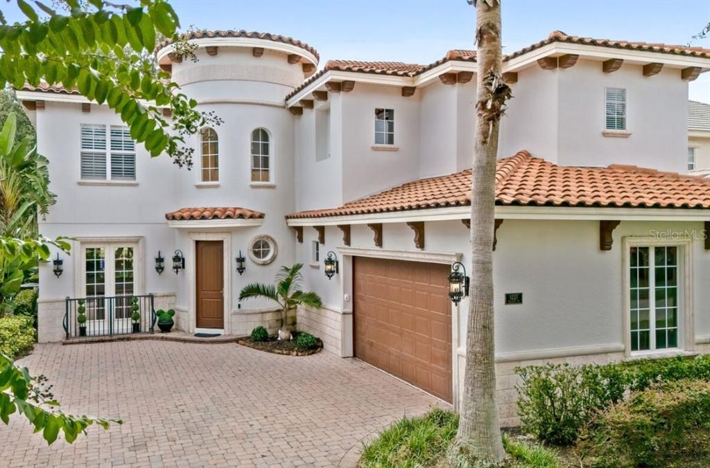 1227 Radiant Street Reunion, FL 34747 - Photo 2 of 70 a front view of a house with a yard and garage