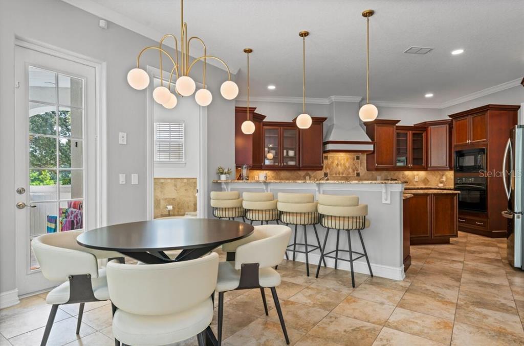 1227 Radiant Street Reunion, FL 34747 - Photo 25 of 70 a large kitchen with a table and chairs