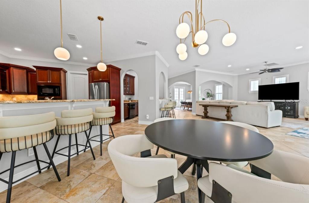 1227 Radiant Street Reunion, FL 34747 - Photo 26 of 70 a large kitchen with a table and chairs