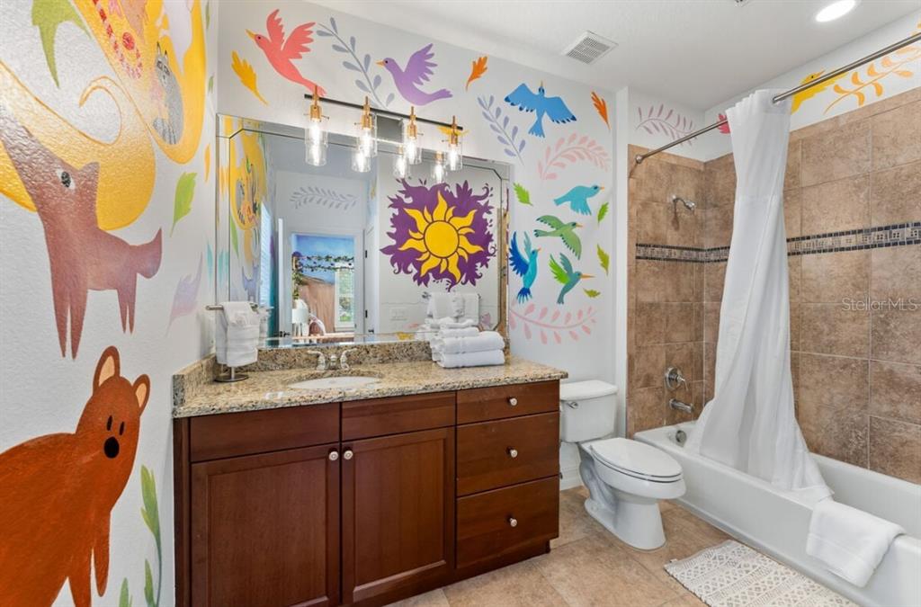 1227 Radiant Street Reunion, FL 34747 - Photo 47 of 70 a bathroom with a sink a vanity and a mirror