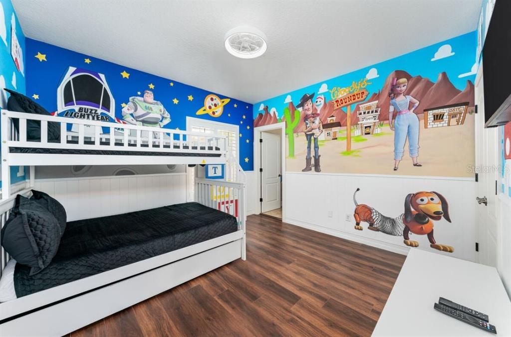 1227 Radiant Street Reunion, FL 34747 - Photo 48 of 70 a living room with stainless steel appliances kitchen island granite countertop a stove and a wooden floor