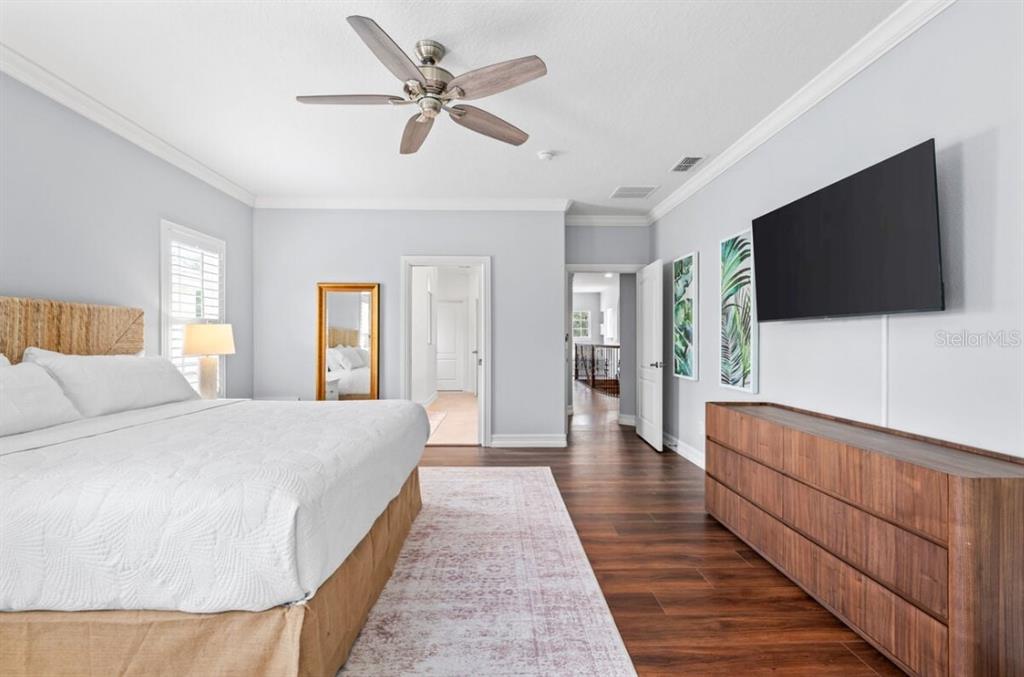 1227 Radiant Street Reunion, FL 34747 - Photo 53 of 70 a the bedroom with a bed and a flat screen television