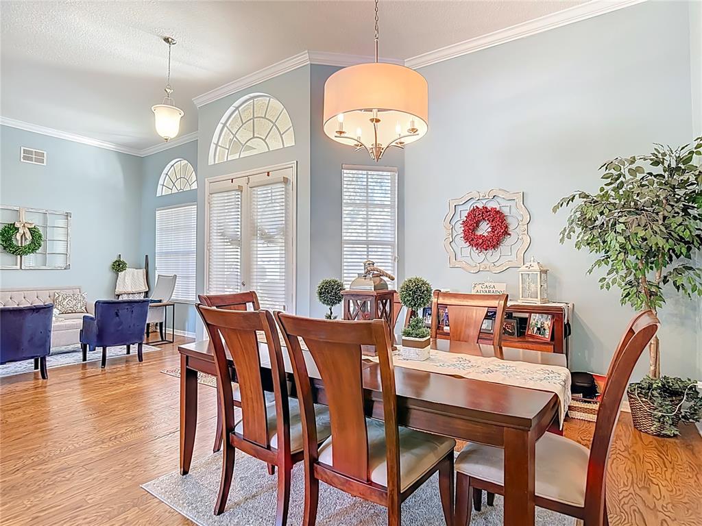 4805 Tea Rose Court Lutz, FL 33558 - Photo 12 of 59 a view of a dining room with furniture window and wooden floor
