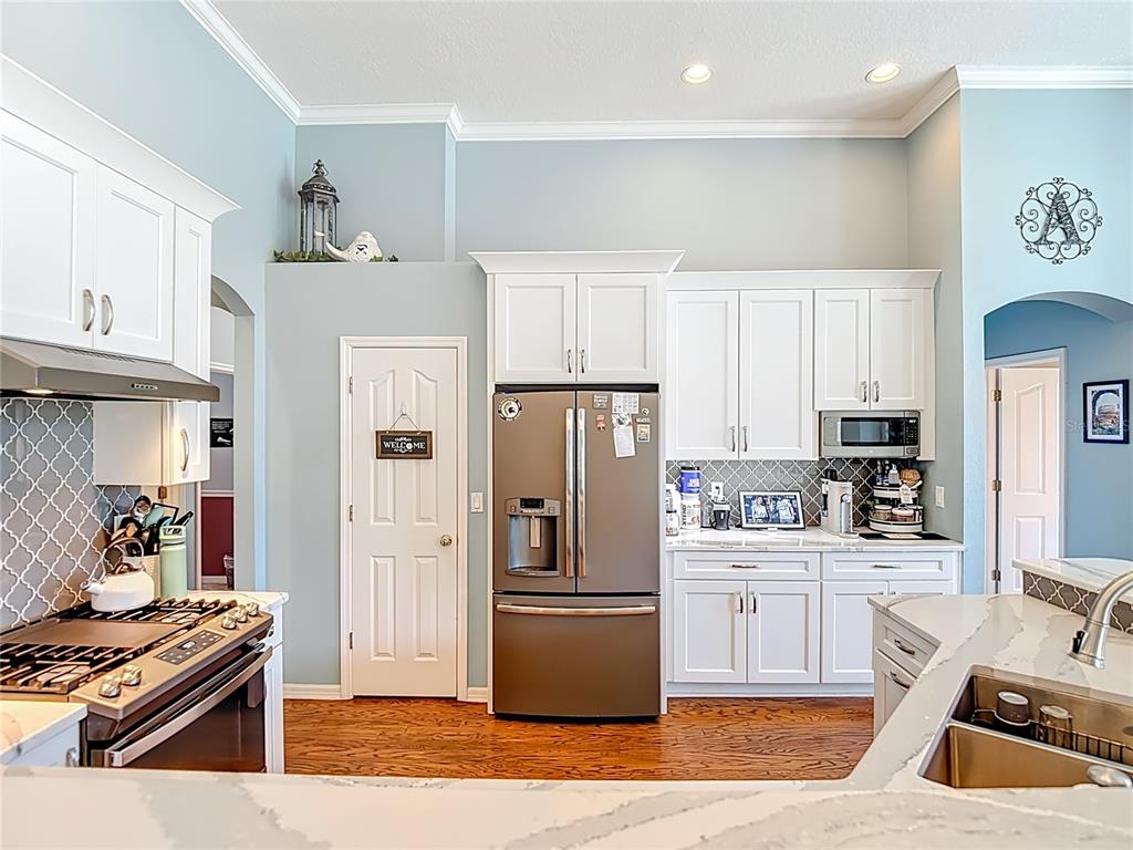 4805 Tea Rose Court Lutz, FL 33558 - Photo 18 of 59 a kitchen with stainless steel appliances granite countertop a refrigerator stove and sink
