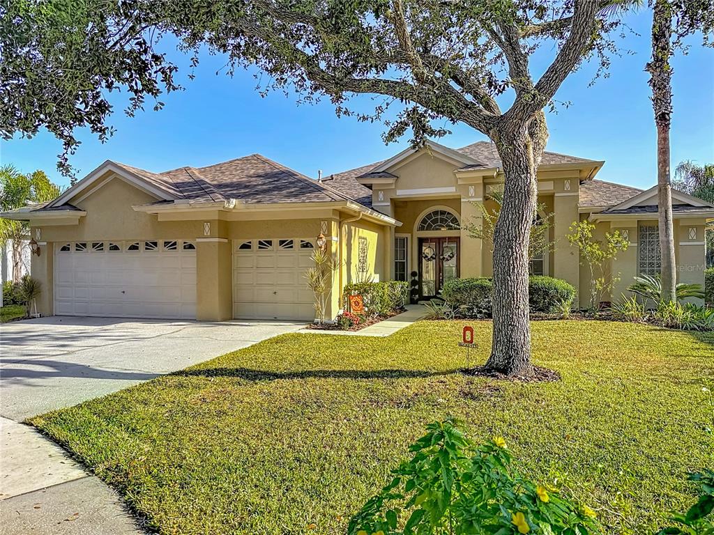 4805 Tea Rose Court Lutz, FL 33558 - Photo 2 of 59 a front view of a house with a yard