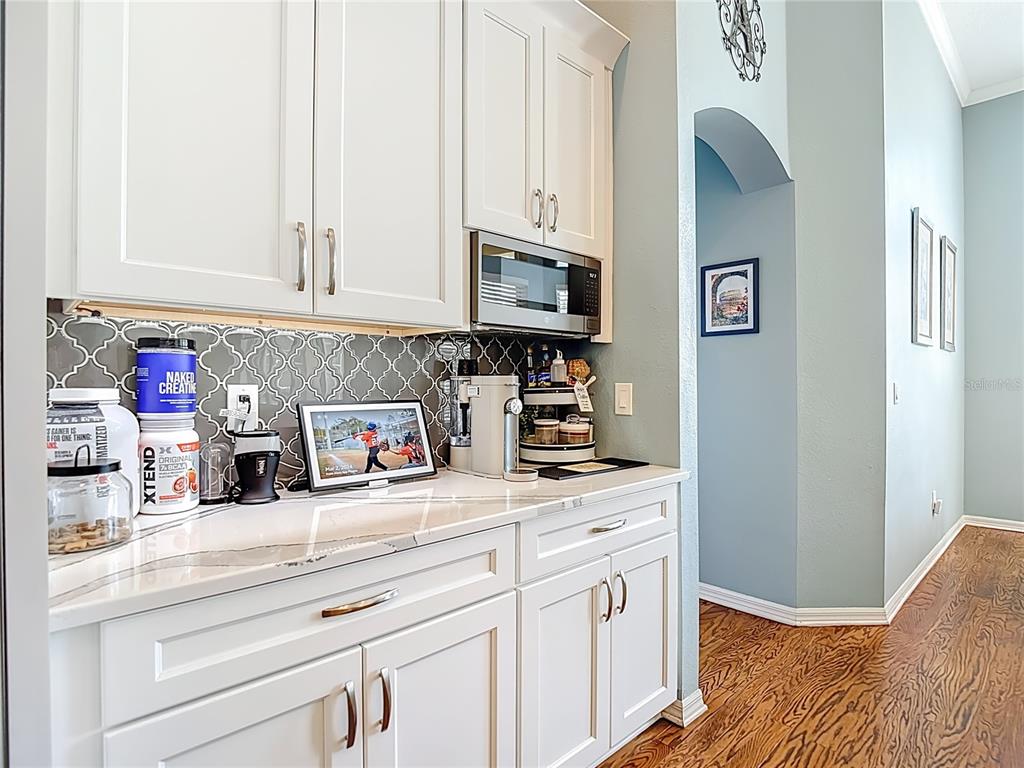 4805 Tea Rose Court Lutz, FL 33558 - Photo 22 of 59 a kitchen with stainless steel appliances granite countertop white cabinets and a sink