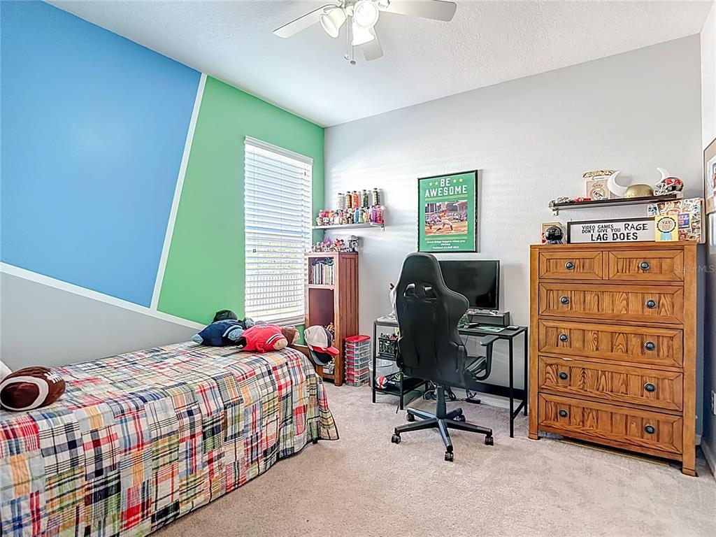 4805 Tea Rose Court Lutz, FL 33558 - Photo 35 of 59 a bedroom with a bed and furniture
