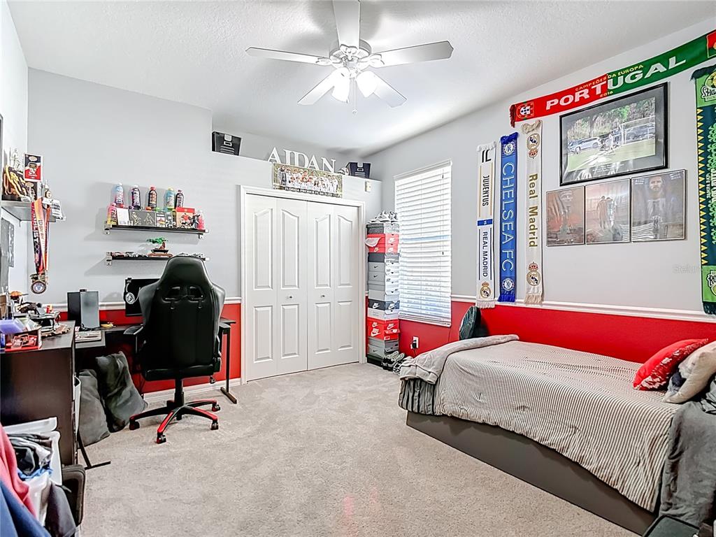 4805 Tea Rose Court Lutz, FL 33558 - Photo 37 of 59 a bedroom with a bed and a window