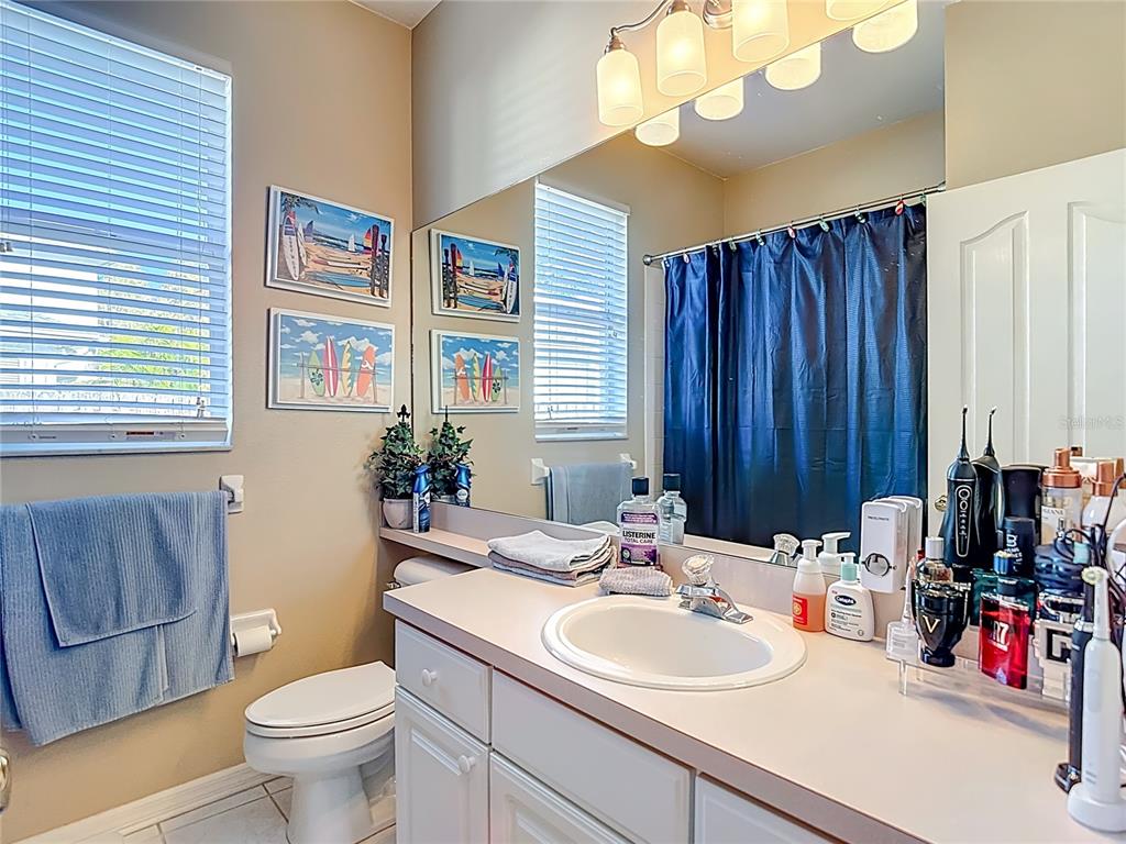 4805 Tea Rose Court Lutz, FL 33558 - Photo 38 of 59 a bathroom with a sink vanity mirror and toilet