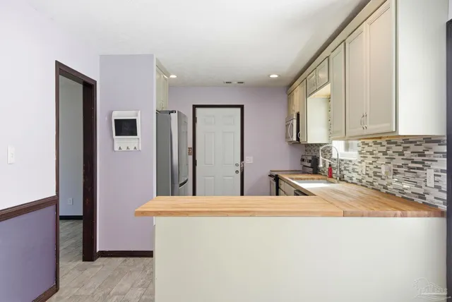 a bathroom with a sink a mirror and a window