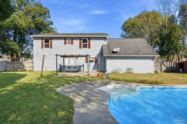 a front view of a house with a yard garage and outdoor seating