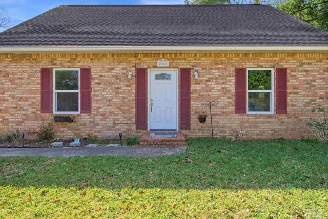 a view of house with backyard