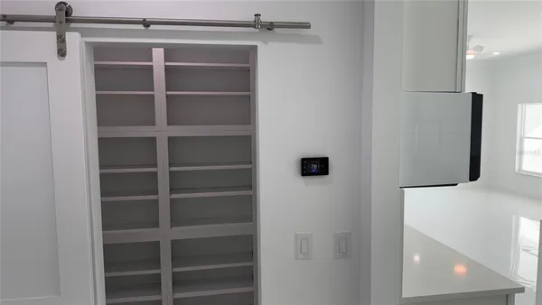a view of walk in closet with empty racks