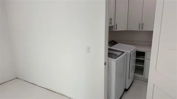 a view of storage and utility room with washer and dryer