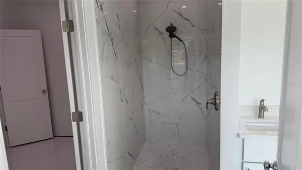 a bathroom with a glass shower door