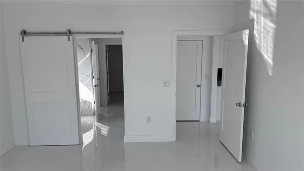 a view of an empty room and a window