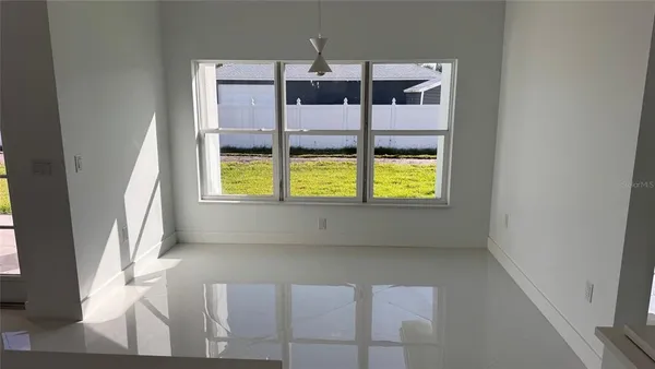 a kitchen with stainless steel appliances a refrigerator a sink a stove a microwave and white cabinets