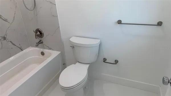 a bathroom with a toilet and a bathtub