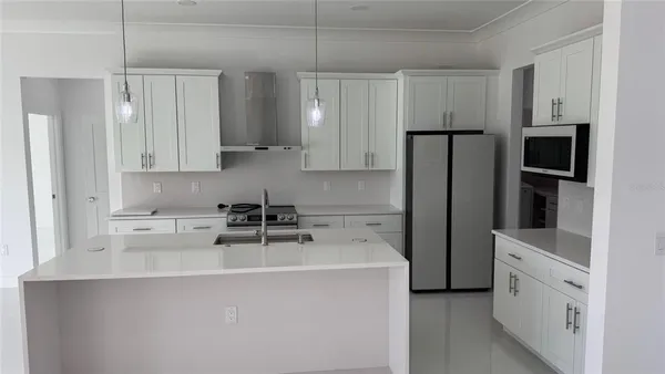 a close view of a faucet a table and chairs in a room